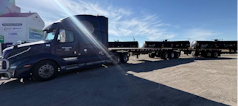 TGQ Transport tractor pulling a super-B flat deck trailer set